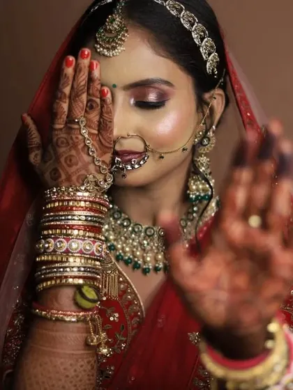 An artistic shot of a bride, highlighting her mehndi and eye makeup.