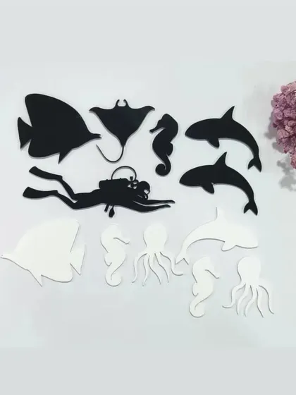 Our ocean art supplies include these black and white acrylic cutouts of sea creatures. The set includes dolphins, a stingray, an octopus, and a scuba diver for creating realistic underwater scenes.