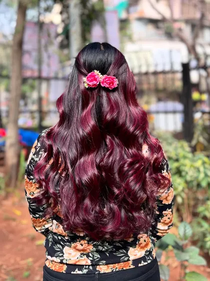The floral accessories add a perfect finishing touch to this stunning wine red hair color.