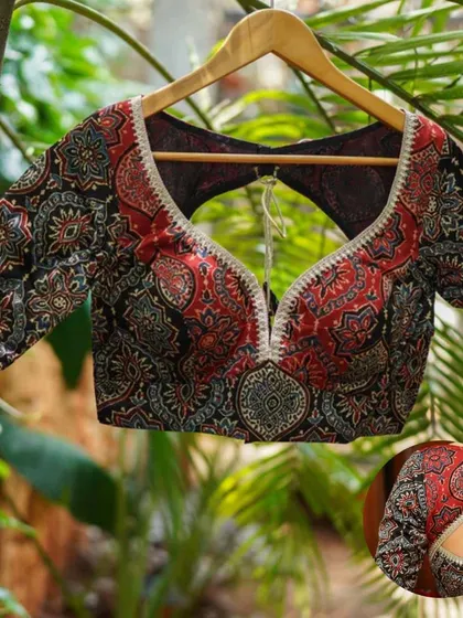 A product shot of our black and red printed blouse with a keyhole back, showcasing the intricate pattern and design.