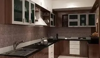 A classic kitchen design with dark wood cabinets, frosted glass upper doors, and a mosaic tile backsplash. This layout demonstrates our ability to work with more traditional aesthetics while ensuring modern functionality.