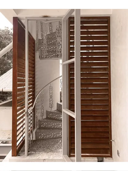 A detail of a spiral staircase with intricately designed steps, turning a functional element into a sculptural piece.