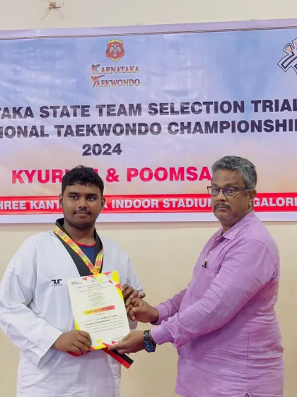 Our coach presenting a certificate to a gold medalist at the Karnataka State Championship selection trials. We secured 14 gold medals in total, with all winners heading to the nationals.