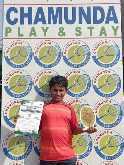 Another angle of Sanjay Girish with his U-12 All India Tennis Association Doubles Runner-Up trophy from the tournament in Karnal.