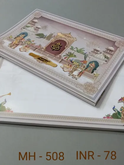 This invitation features a detailed illustration of a traditional ceremony with a Ganesha emblem. The design is rich in cultural motifs and perfect for a classic wedding.