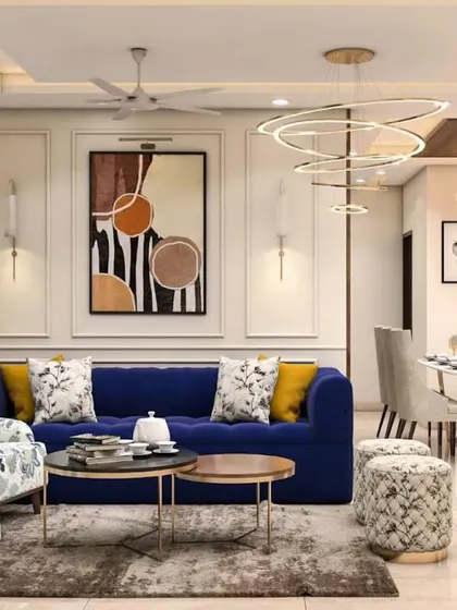 A vibrant living and dining area featuring a royal blue sofa, a floral armchair, and modern circular chandeliers. The open-plan layout is perfect for a family that loves to entertain.