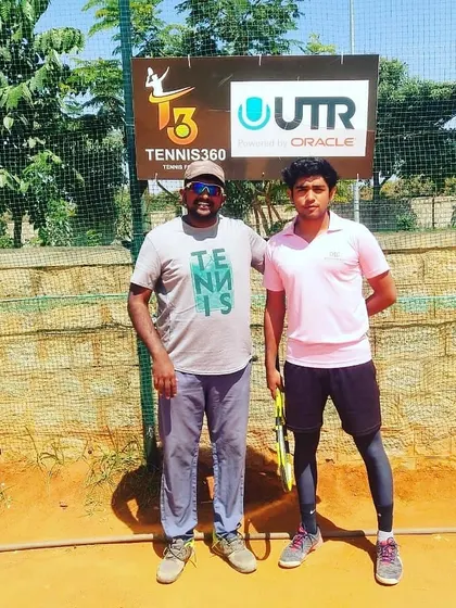 A UTR tournament participant stands with a coach in front of the official Tennis360 and UTR branding.