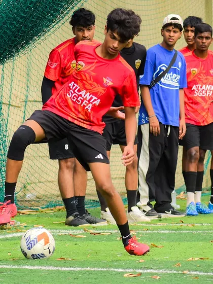 A player setting up for a free-kick, with his teammates providing support.