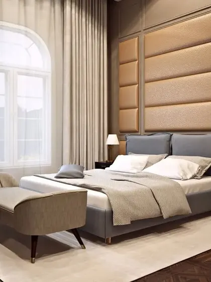 A master bedroom suite in our Chattarpur bungalow project, blending comfort with classic design. The room features a custom upholstered headboard, elegant wall paneling, and arched windows, reflecting a cohesive luxury design language throughout the home.
