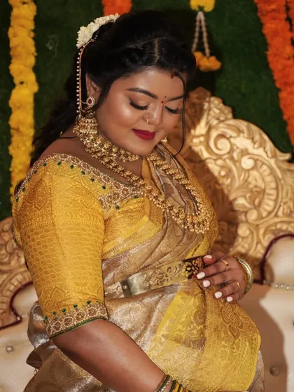 A beautiful candid of the mom-to-be during her baby shower. The makeup highlights her features with a soft glam finish and a classic red lip.