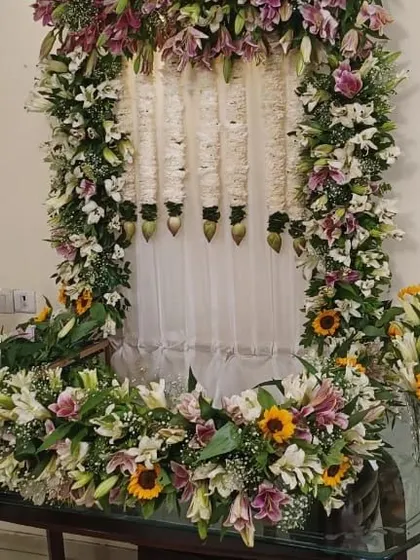 The Ganpati mandap decorated with lilies and sunflowers, creating a bright and cheerful space for the festival.