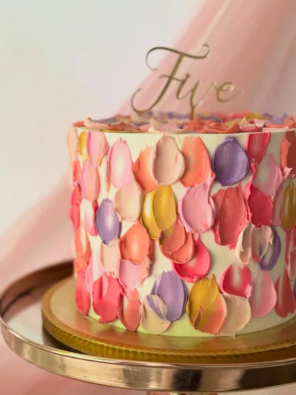 A close-up view of the palette knife buttercream cake, highlighting the texture and blend of warm colors.
