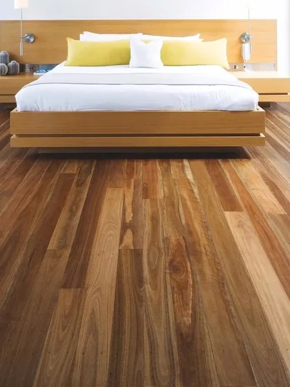 For this modern bedroom, I used a dark-toned wood floor to create a sophisticated and calming retreat. The rich color of the wood grounds the space and pairs beautifully with the minimalist wooden bed frame.