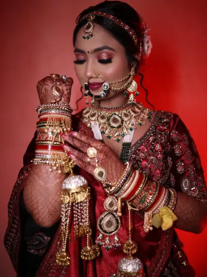 A closer look at this bride's stunning look. I focused on her beautiful eyes and gave her a classic bridal hairstyle, complete with a traditional nath and maang tikka. She is holding her kalire, ready for her big day.