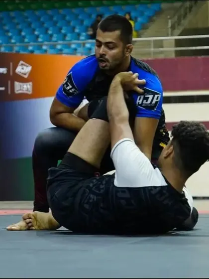 Working from the top position in an opponent's guard during a competition. The focus here is on posture and pressure to begin breaking down their defense and start a guard pass.