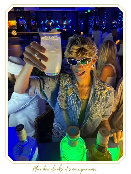 A guest with a cool, edgy style raises his glass at the bar. We cater to all types of crowds and events, ensuring everyone has a great time.