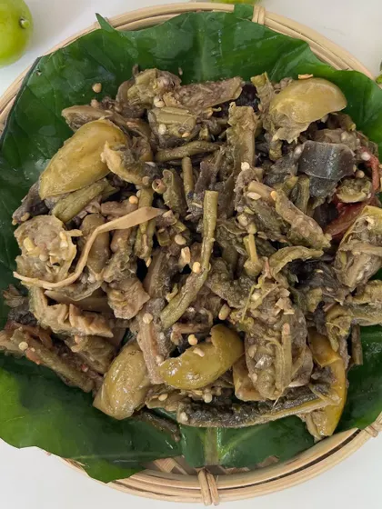 A close-up of our 'Rusep' served on a banana leaf. The mix of textures and flavors from the various wild vegetables makes this a must-try side dish to accompany your meal.