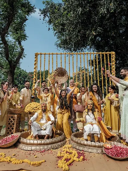 The warmth of Haldi and the joy of togetherness. The whole family comes together to shower the couple with flowers and blessings.