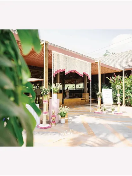 A wider view of the entrance at Panchavati the Pavilion, with its fragrant floral decor and inviting welcome sign.