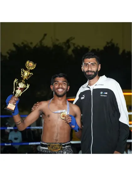 A champion and his coach. Posing with the trophy and gold medal after a big win at the state level Muay Thai championship. This is what we work for.