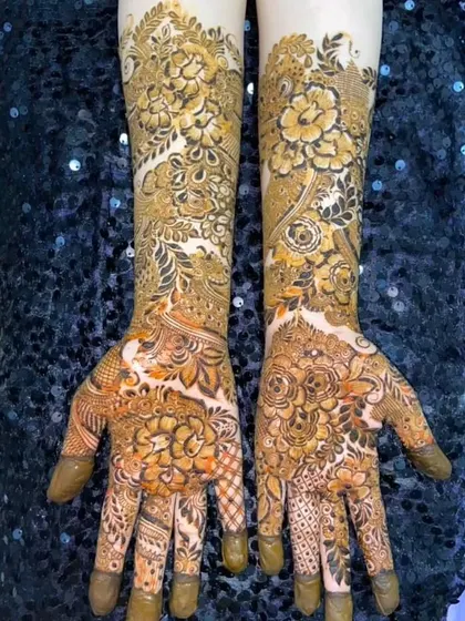 The fresh henna paste of a full floral bridal design. The two-tone effect of the paste shows the different layers and details I create.