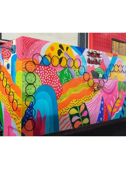 Another view of the colorful abstract wall art. The design is a mix of organic shapes, geometric patterns, and playful lines.