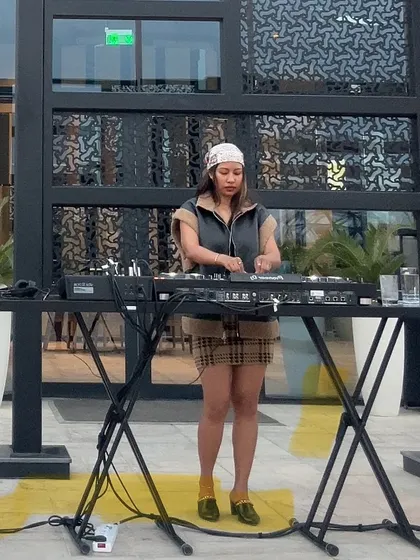 A full-length shot showing my DJ setup and my chic outfit for the day's work.