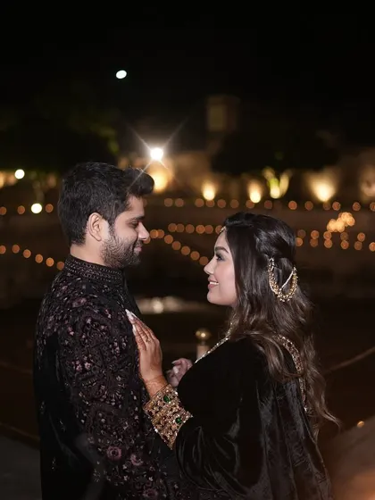 A romantic moment between the couple, illuminated by the soft glow of hundreds of candles at their Jaipur sangeet.