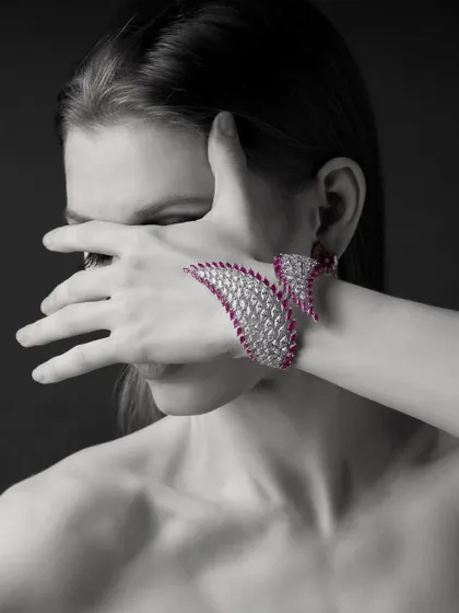 A dramatic, artistic pose to showcase this incredible ruby and diamond hand-cuff from Yoube Jewellery. The black and white photo with the pop of red creates a powerful, high-fashion statement.