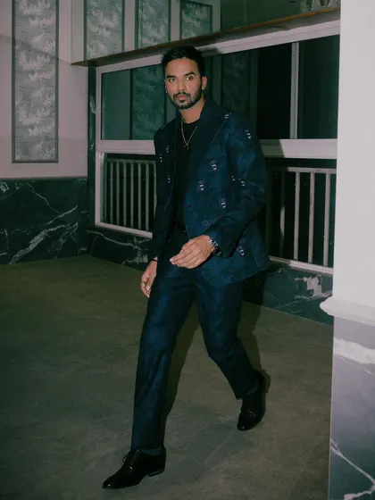 Shakti Yadav wears our dark blue suit effortlessly, showcasing the signature SGM logo motif embroidered on a matte-finished wool jacket.