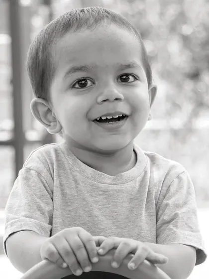 Children are living messages we send to a time we will not see. This simple, happy black and white portrait captures the timeless joy of childhood.
