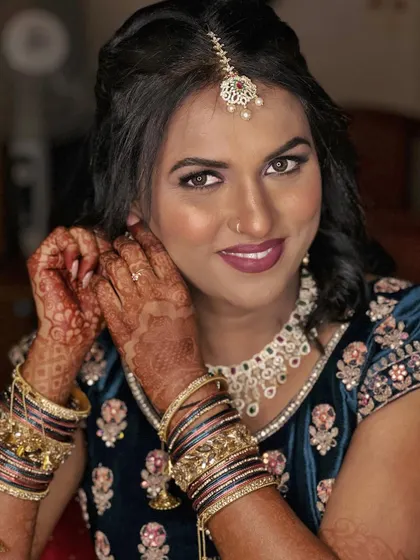 A beautiful portrait of Simran for her engagement. We chose a halo eye effect with purple and blue tones to complement her velvet lehenga, paired with a bold berry lip.