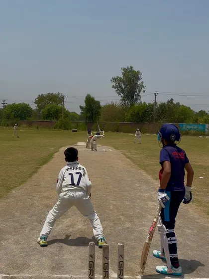 A view from behind the stumps as the bowler runs in.