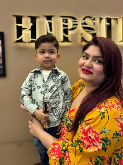 A happy mom with her son, who is sporting a fresh and stylish new haircut.