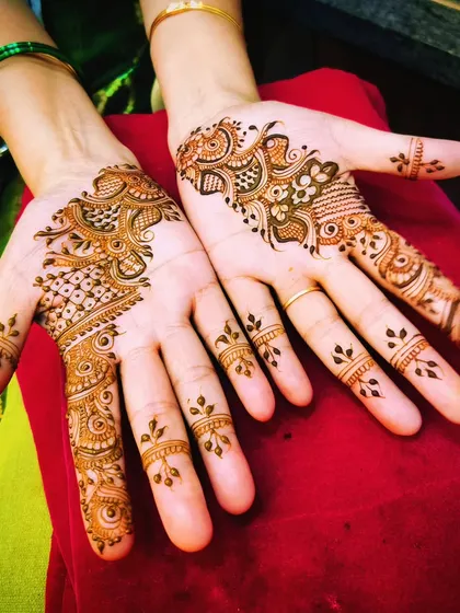 A matching pair of asymmetrical party designs. This is a great option for friends or family members who want complementary mehendi.
