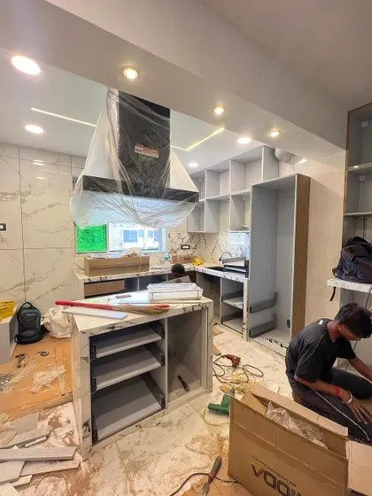 A behind-the-scenes look at our team during the kitchen installation process. Here, we are assembling the custom cabinetry and island, ensuring a perfect fit and finish for all components.