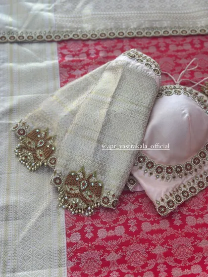The sleeves feature heavy zardosi motifs.