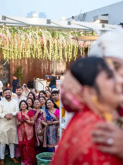 A blurry, artistic shot of the couple kissing, with the guests watching in the background. This photo captures the feeling of being in a bubble of love.