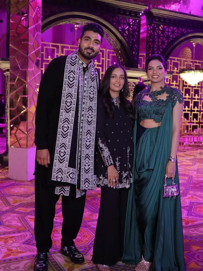 A group photo showing the couple with me. This demonstrates my hands-on approach to styling not just the bride, but the groom and family for a cohesive event.