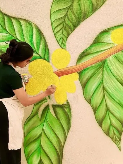 Layer by layer, stroke by stroke. Adding yellow blossoms to a coffee plant mural I created for a Coffee Nation outlet.