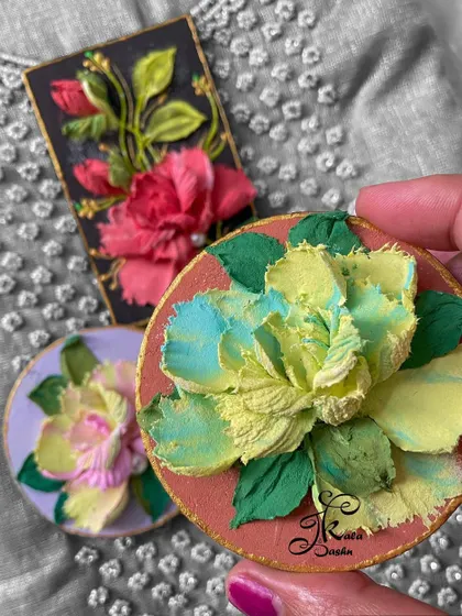 A collection of three distinct fridge magnets, showcasing different color palettes and flower styles.