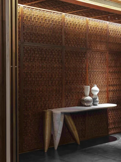 We believe in reviving heritage crafts within contemporary contexts. For this dining room, we commissioned intricate Pinjirakari lattice work, transforming the walls and ceiling into a jewel box that filters light and creates an atmosphere of intimate, handcrafted luxury.