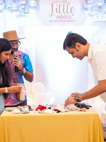 A 'guess the baby item' game, where guests are blindfolded and have to identify different baby essentials.