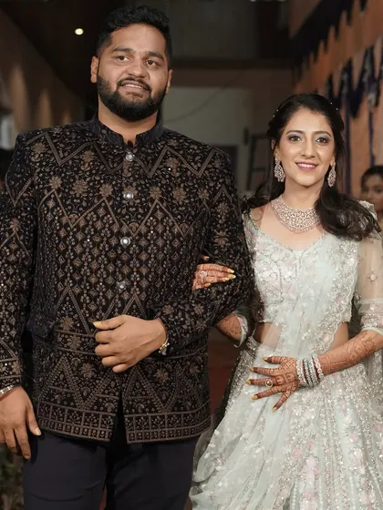 The happy couple at their Sangeet. The bride's makeup is fresh and radiant, designed to withstand an evening of fun and celebration, while the groom looks naturally polished.