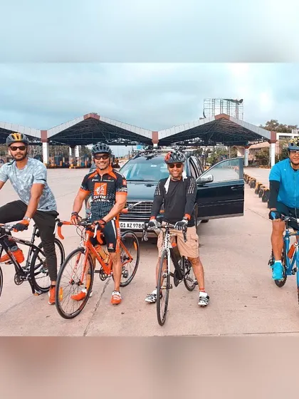 A group photo at a toll plaza, a common landmark on our long-distance cycling routes.