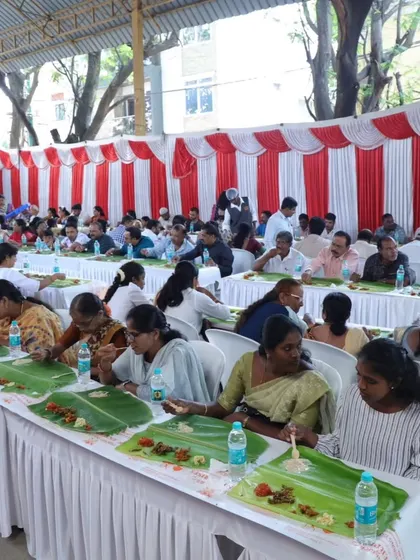 We handle events of all sizes, providing both decoration and our signature Andhra catering. Here you can see a large gathering enjoying a traditional meal on banana leaves under a professionally decorated pandal.