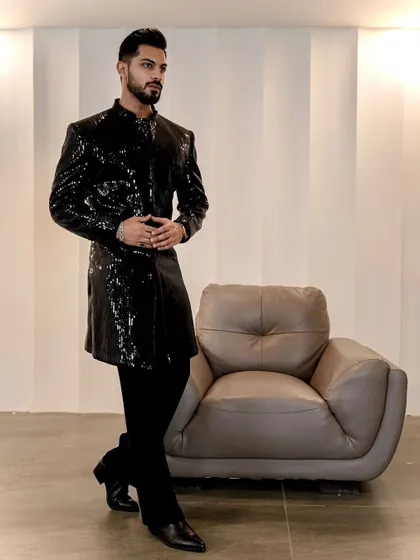 A modern statement for evening events. This black sequined Indo-Western jacket is tailored for a sharp, powerful silhouette, offering a glamorous and contemporary option for cocktail parties and wedding receptions.