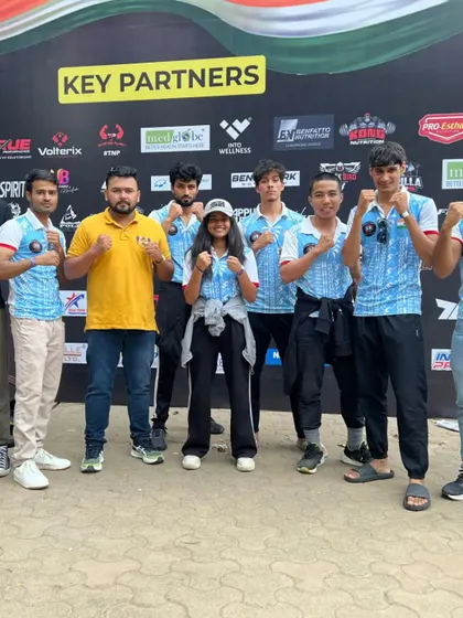 The full team posing with their coaches at the MMA National Championship in Mumbai.