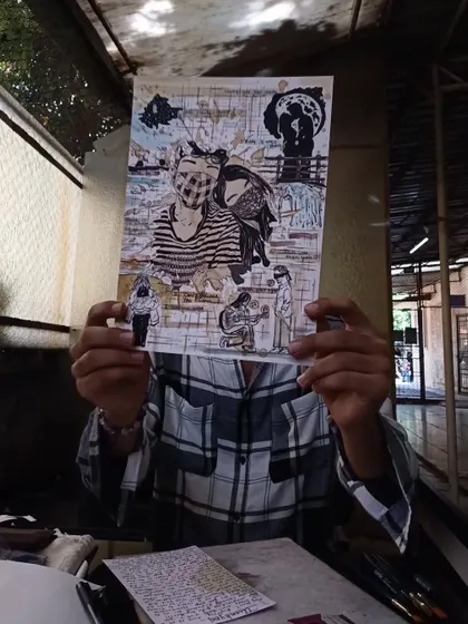 Holding up a finished memory collage. This piece tells a love story through a collection of illustrated moments, inside jokes, and meaningful symbols, all brought together with coffee art.