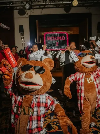 Mr. Teddy and his crew making it rain with fake money, a signature move from the Toy Room Club theme that gets everyone hyped up.